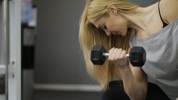 Girl doing dumbbell exercise